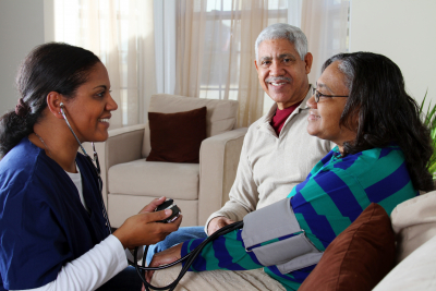 home health care worker and an elderly couple