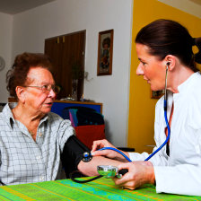 nurse checking the senior woman's health
