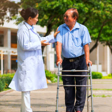nurse talking to senior man on walker